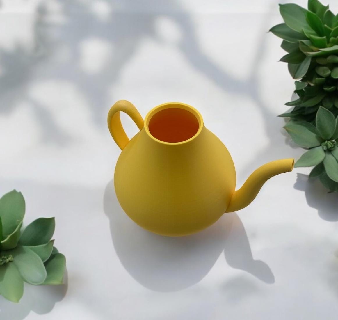Yellow Modern Watering Can in window with greenery – modern sculptural watering can