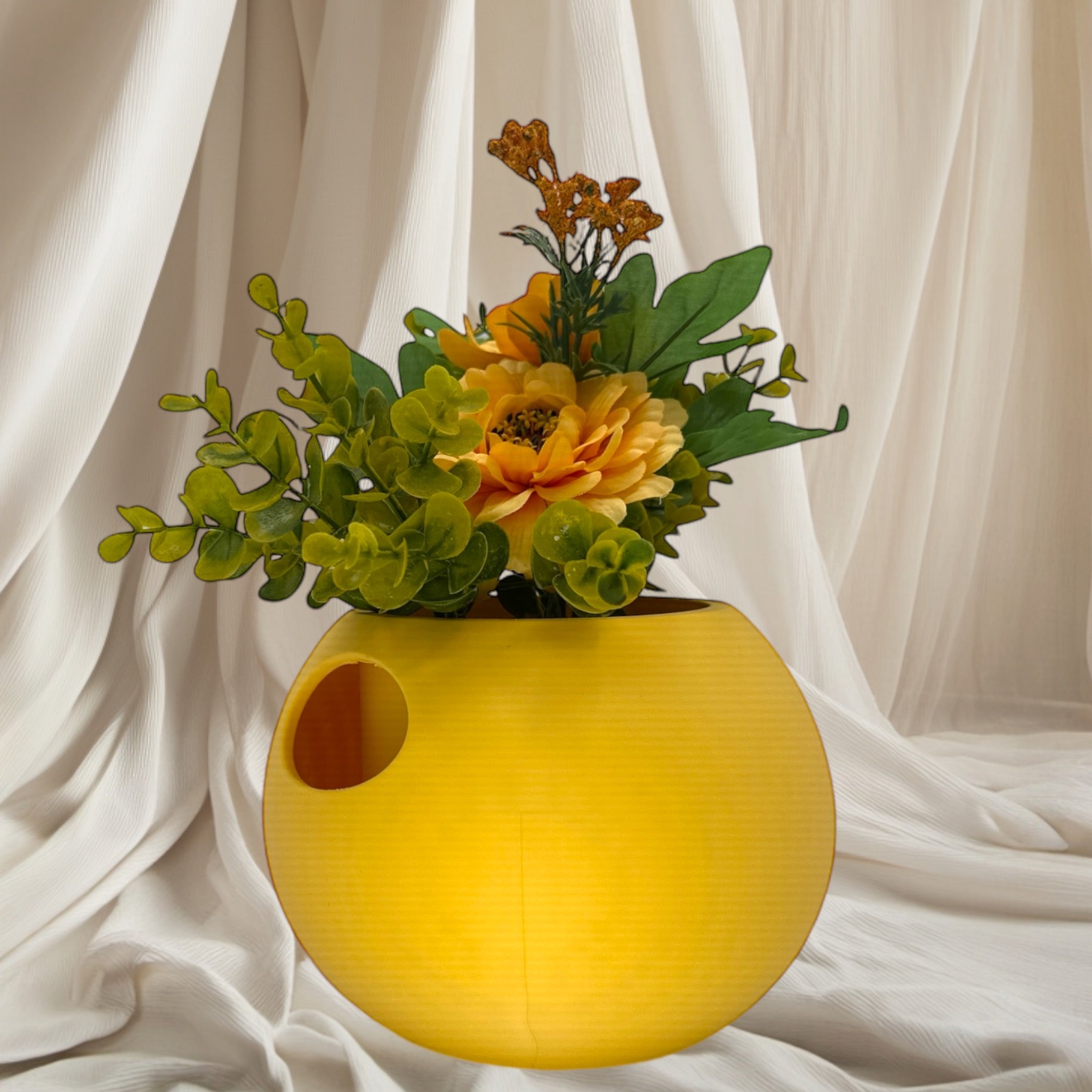 Lemon Yellow Self-Watering Sphere Planter with floral arrangement – sculptural sphere planter