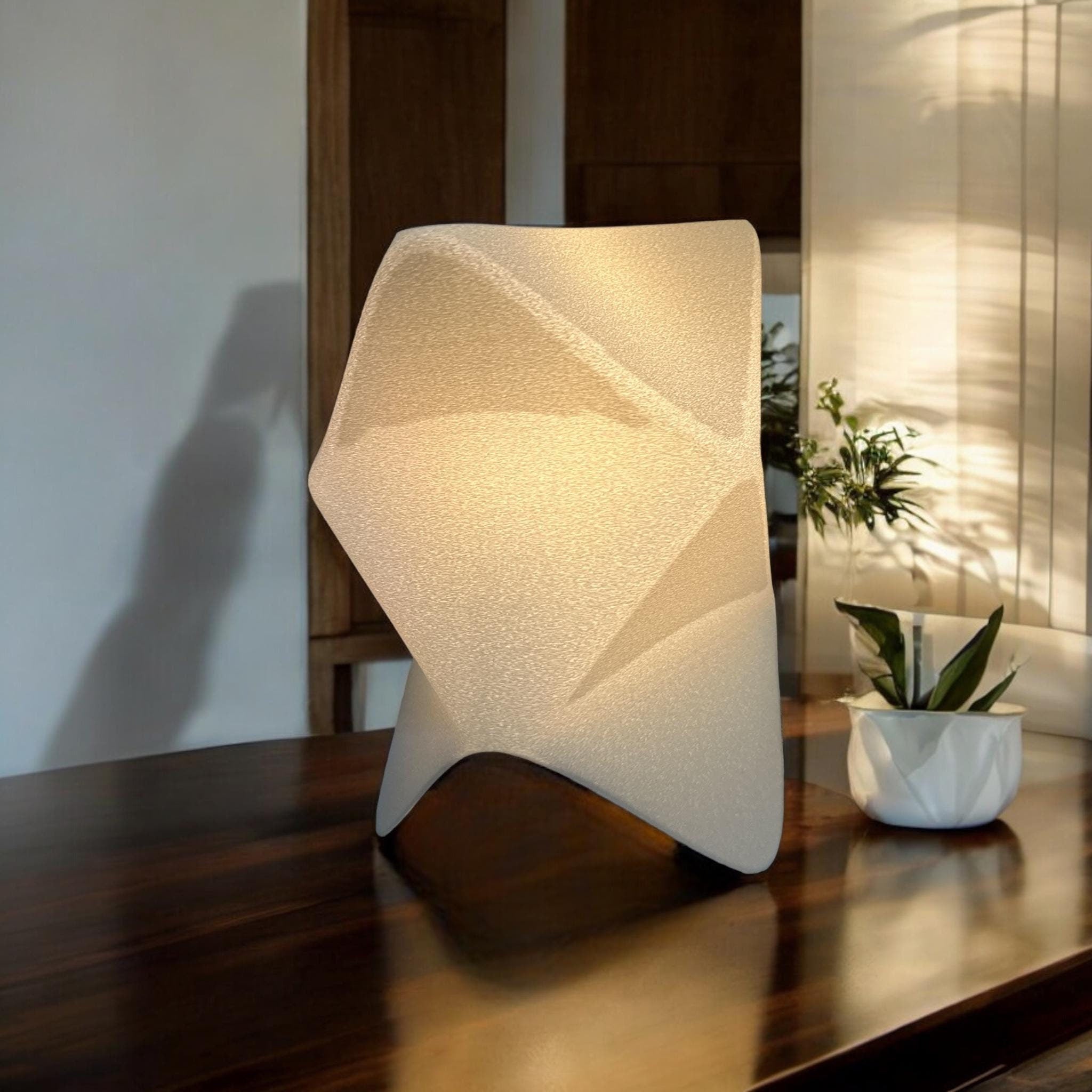 Origami table lamp glowing with warm ambient light by Pashmation