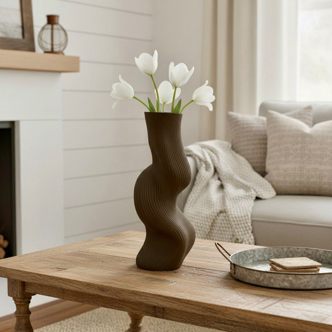 Brown Uzoo Tanasul Vase styled on tall stand – sculptural wave centerpiece