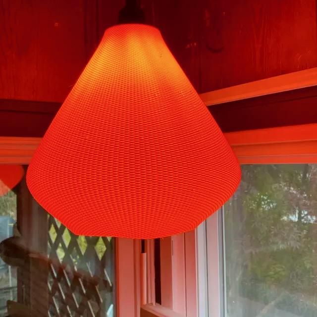 Orange Woven Pendant Light hanging in modern interior – textured conical ceiling lamp shade