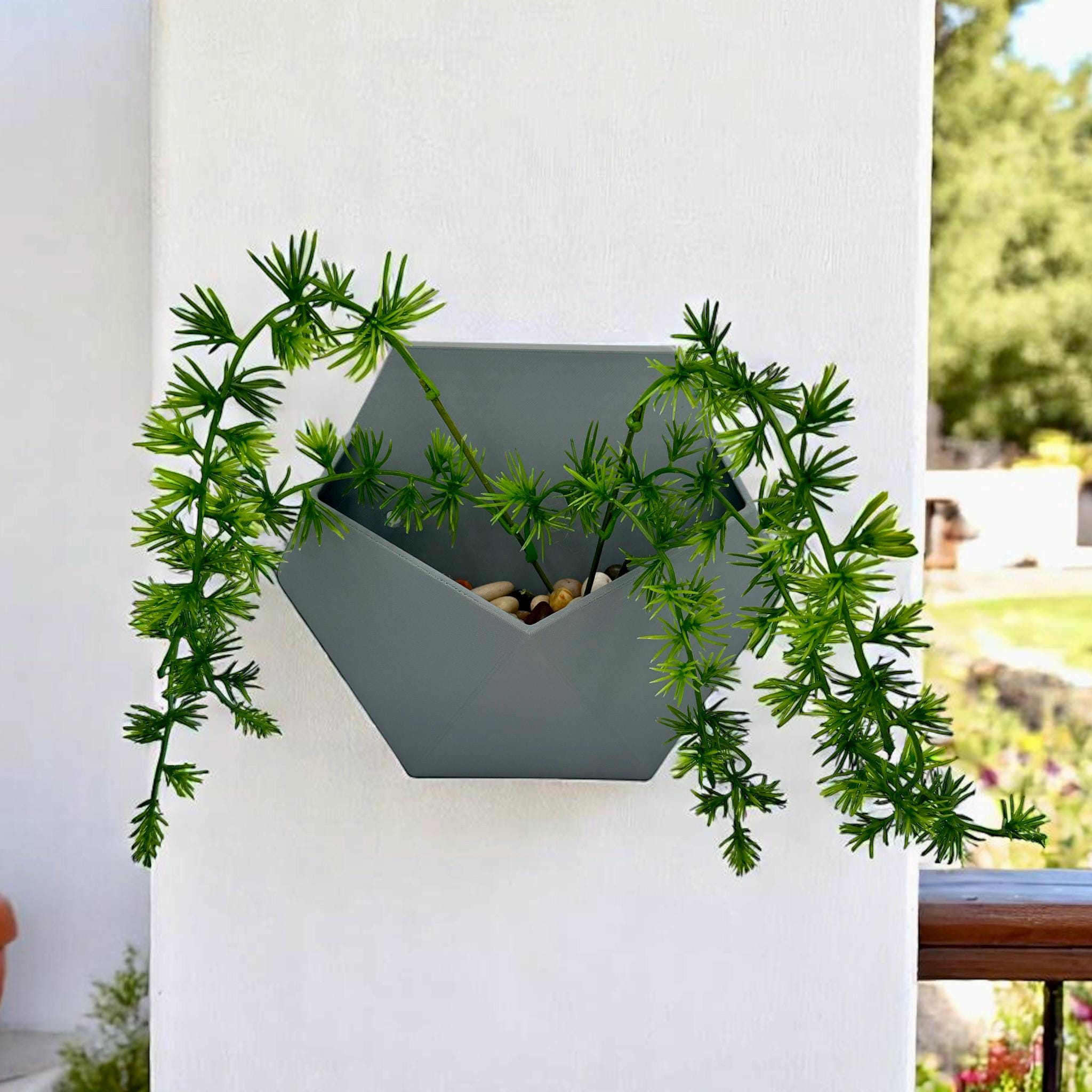 Geometric Wall Planter with trailing greenery – hexagonal prism wall-mounted planter