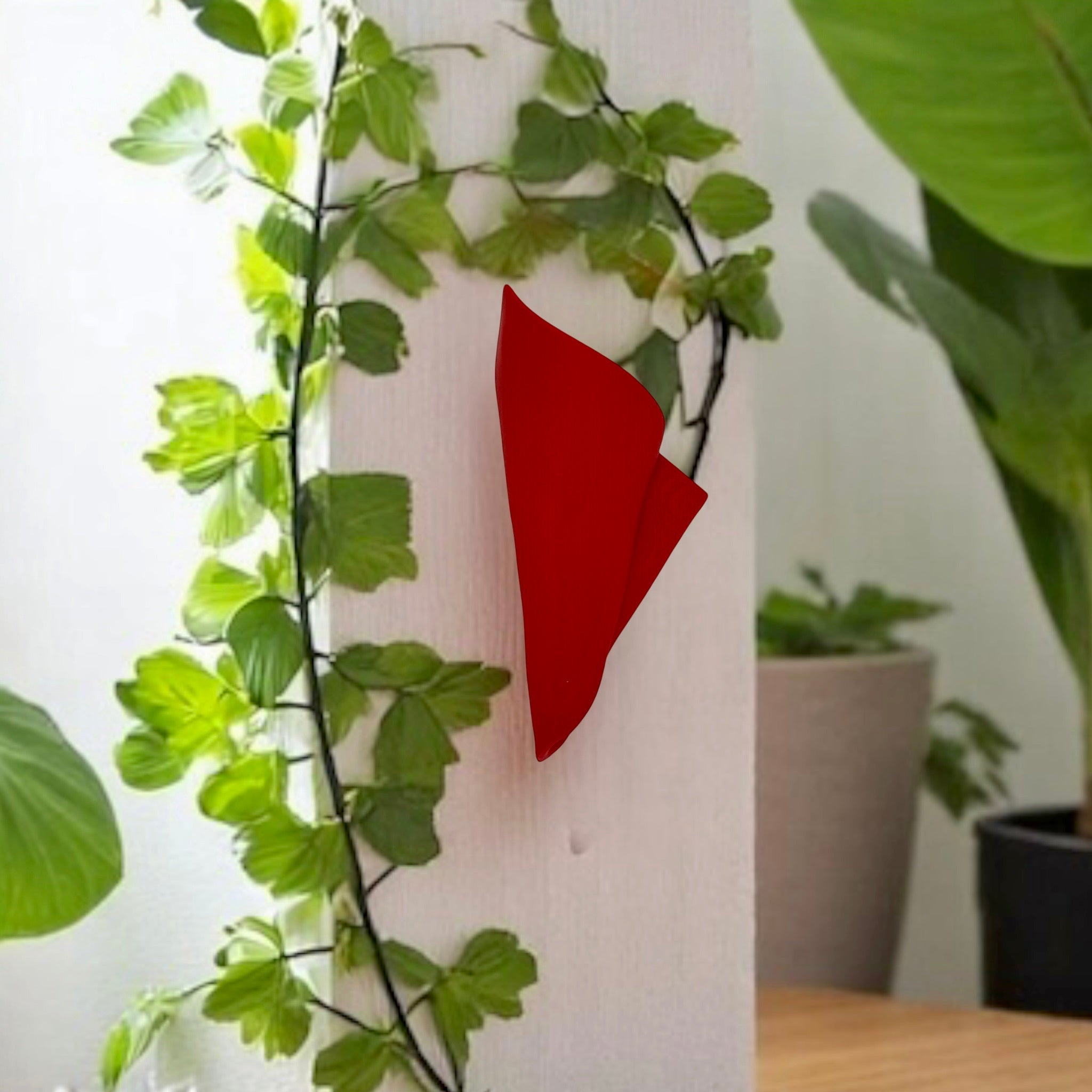 Red vertical wall napkin wall vase displayed as modern wall decor by Pashmation
