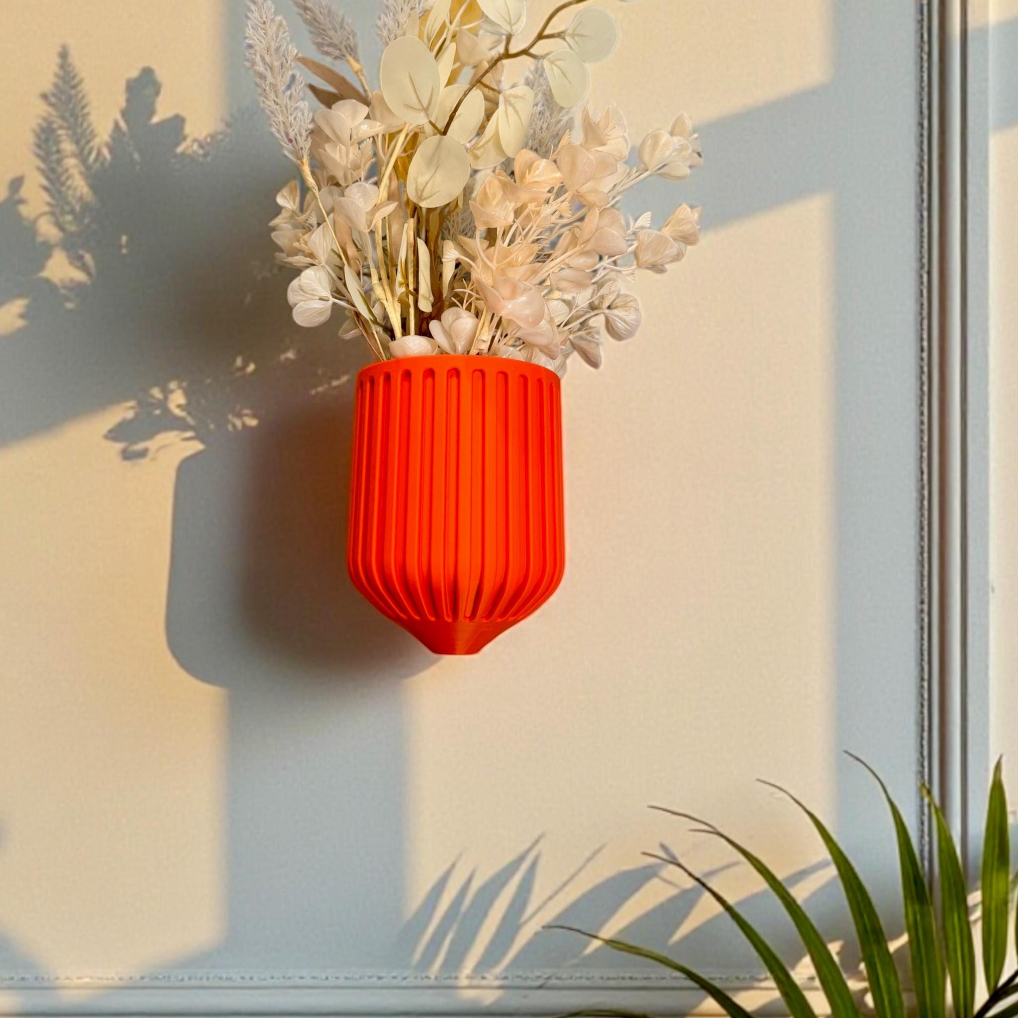 Orange Nordic Wall Vase with trailing pothos – ribbed sculptural wall-mounted decor