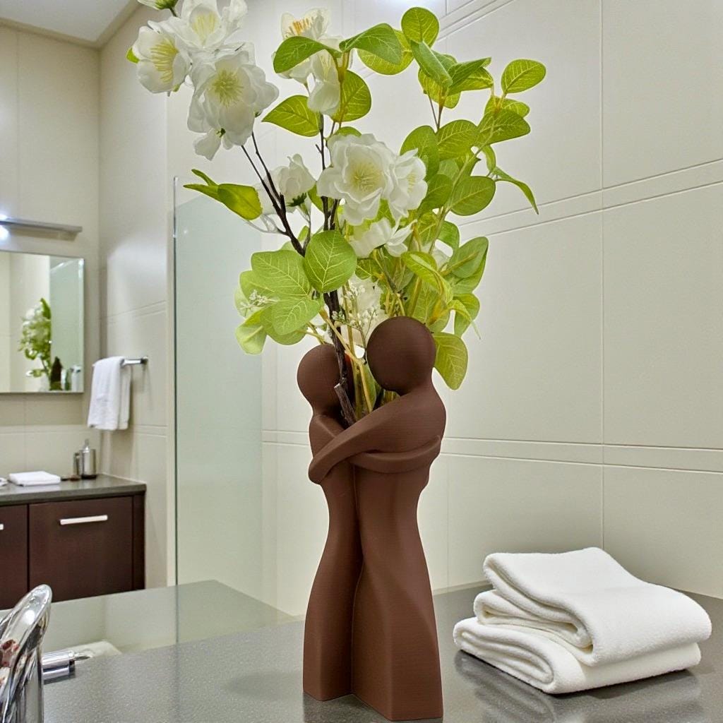 Brown Embrace Vase styled with dried botanicals – figural love symbol decor