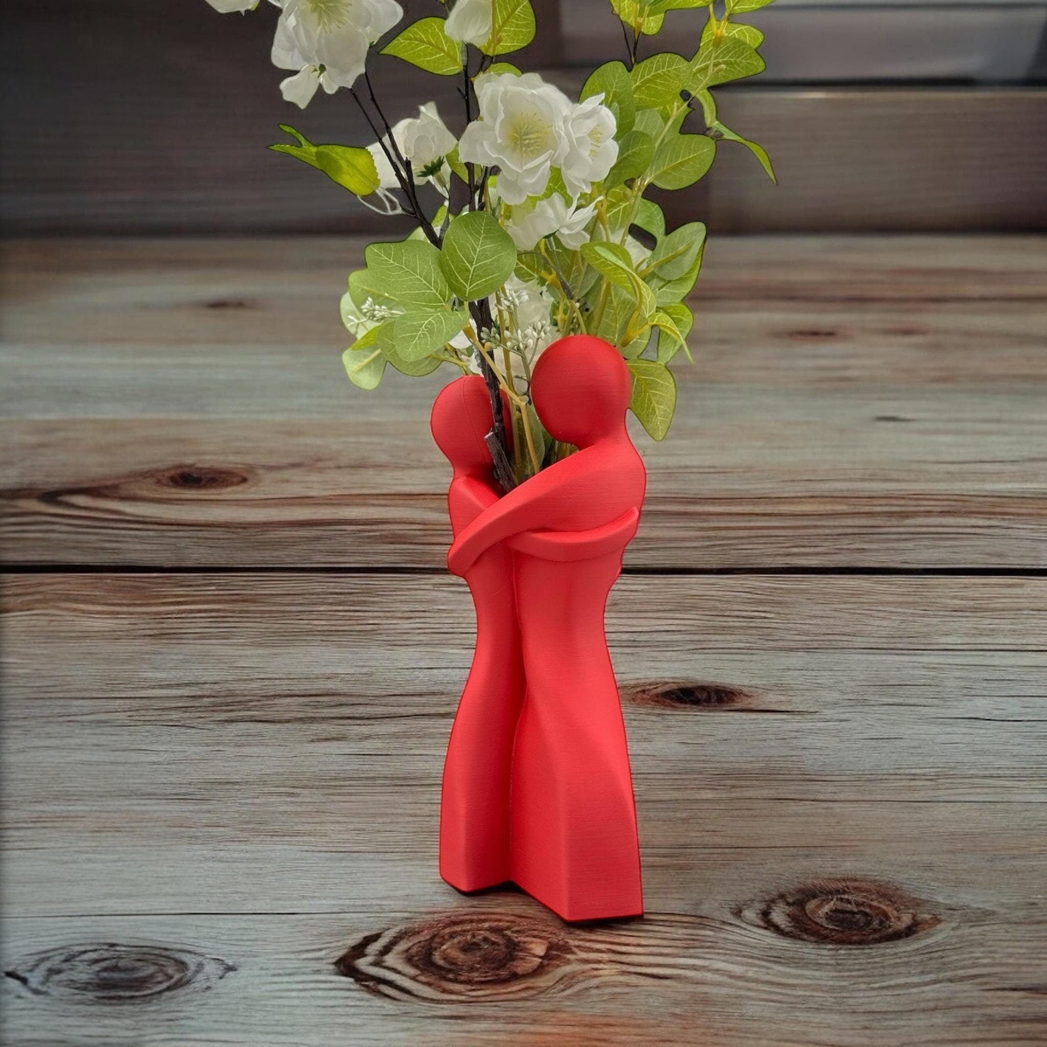 Red Embrace Vase styled with dried botanicals – figural love symbol decor