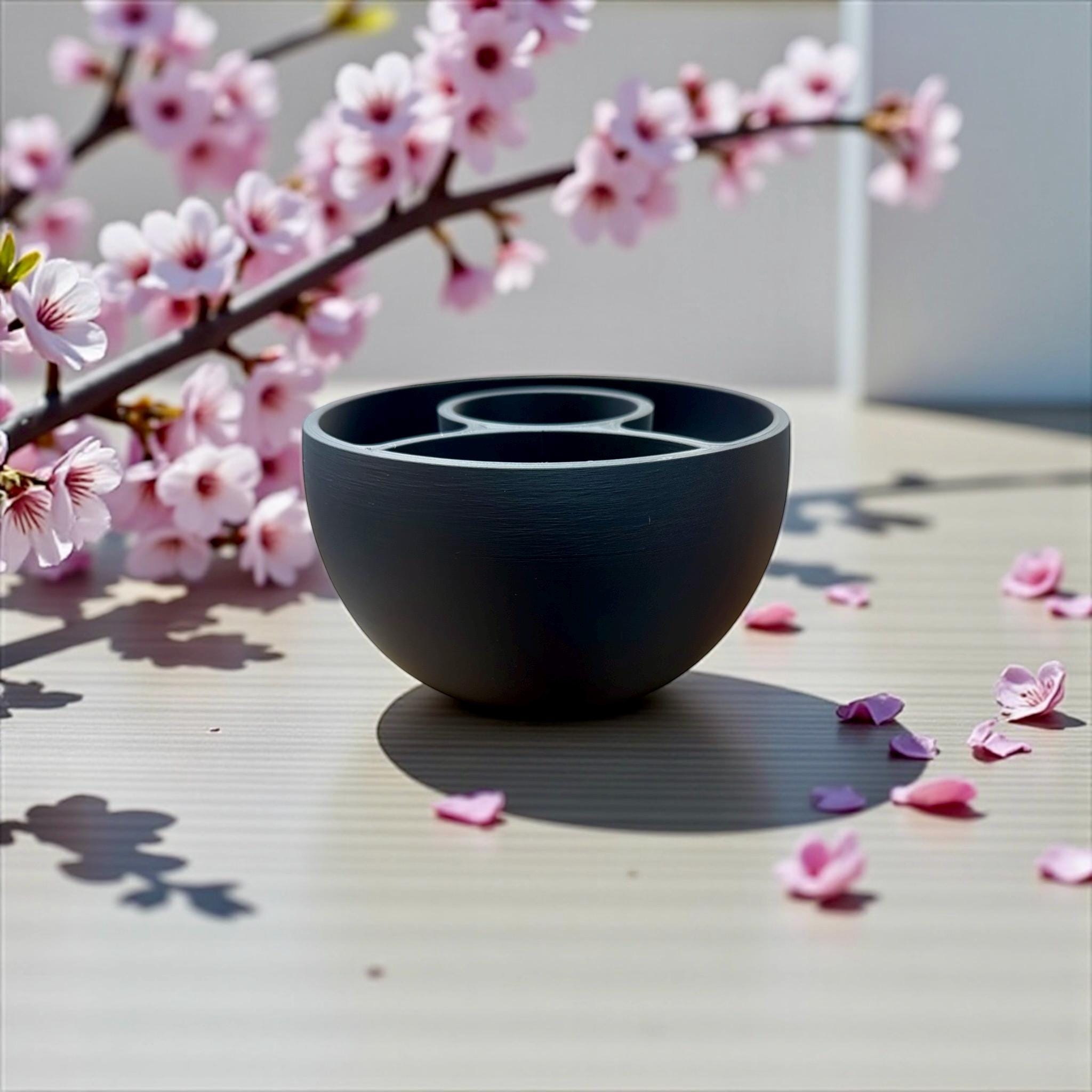 Black Multi-Plant Self-Watering Planter styled with cherry blossom branches – modern bowl-form planter