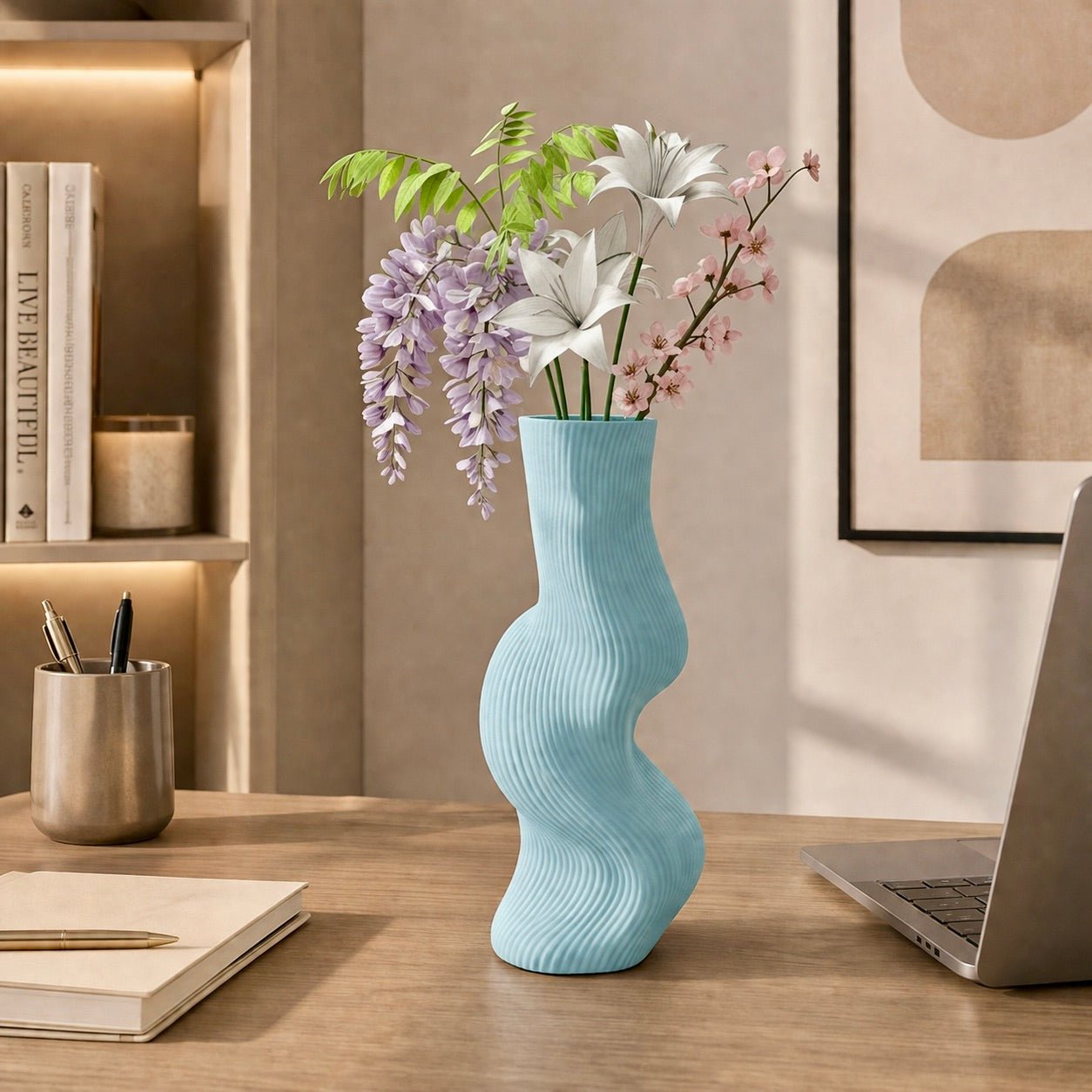 ice blue Uzoo Tanasul Vase styled on tall stand – sculptural wave centerpiece