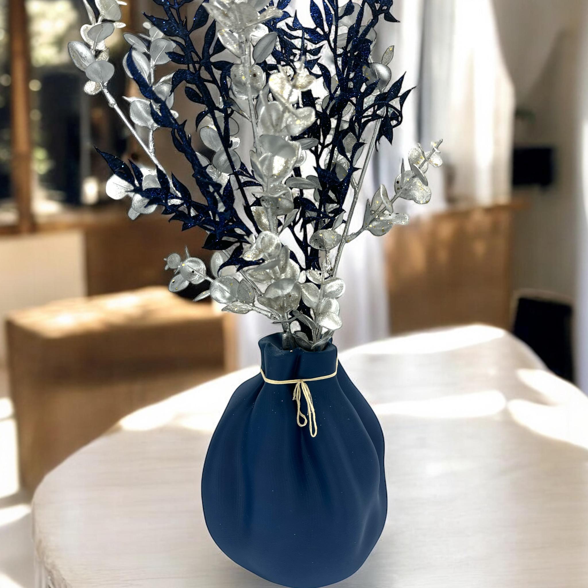 Black Cinched Wave Vase on dining table – soft sculptural pouch centerpiece